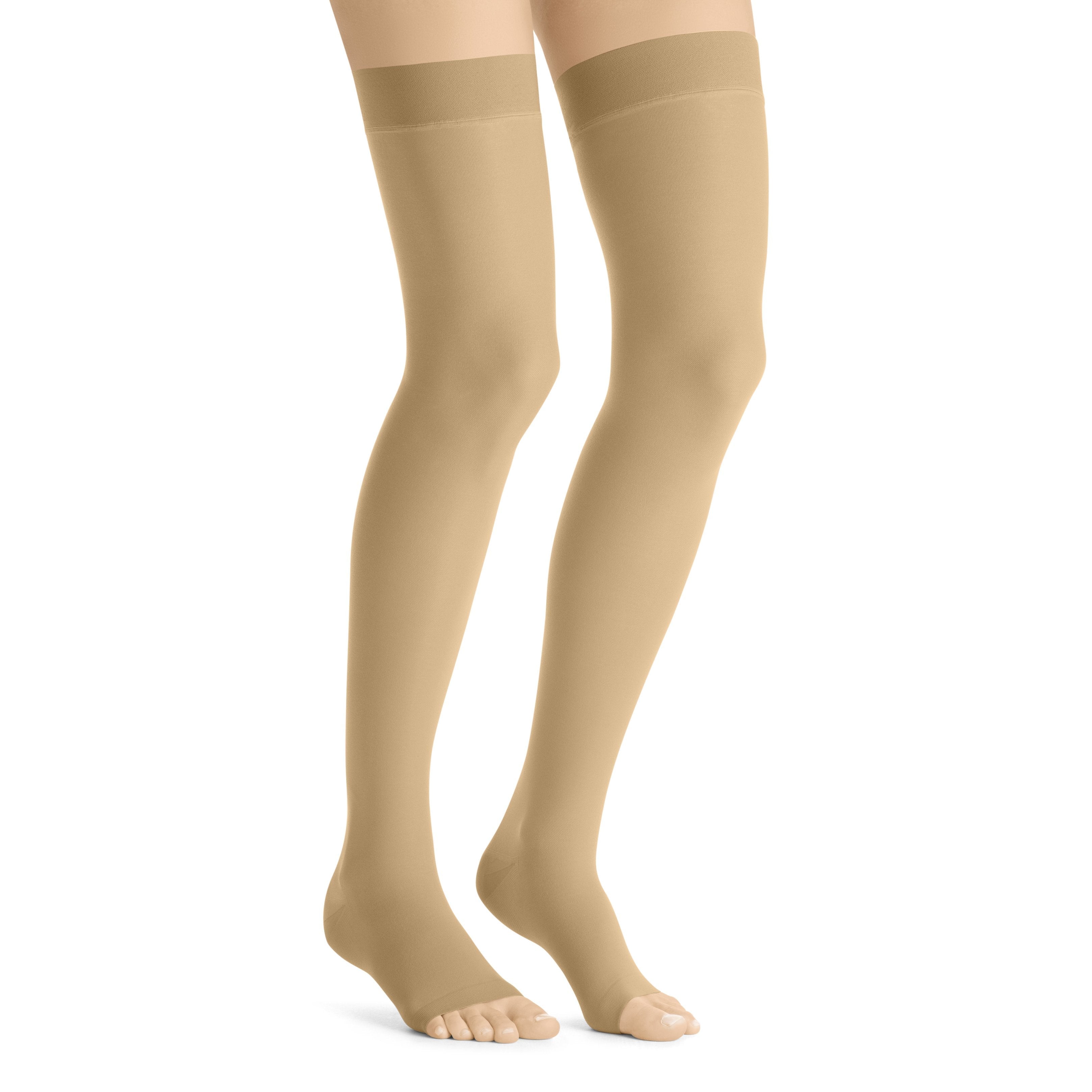 Sheer thigh high compression stockings worn on a pair of legs