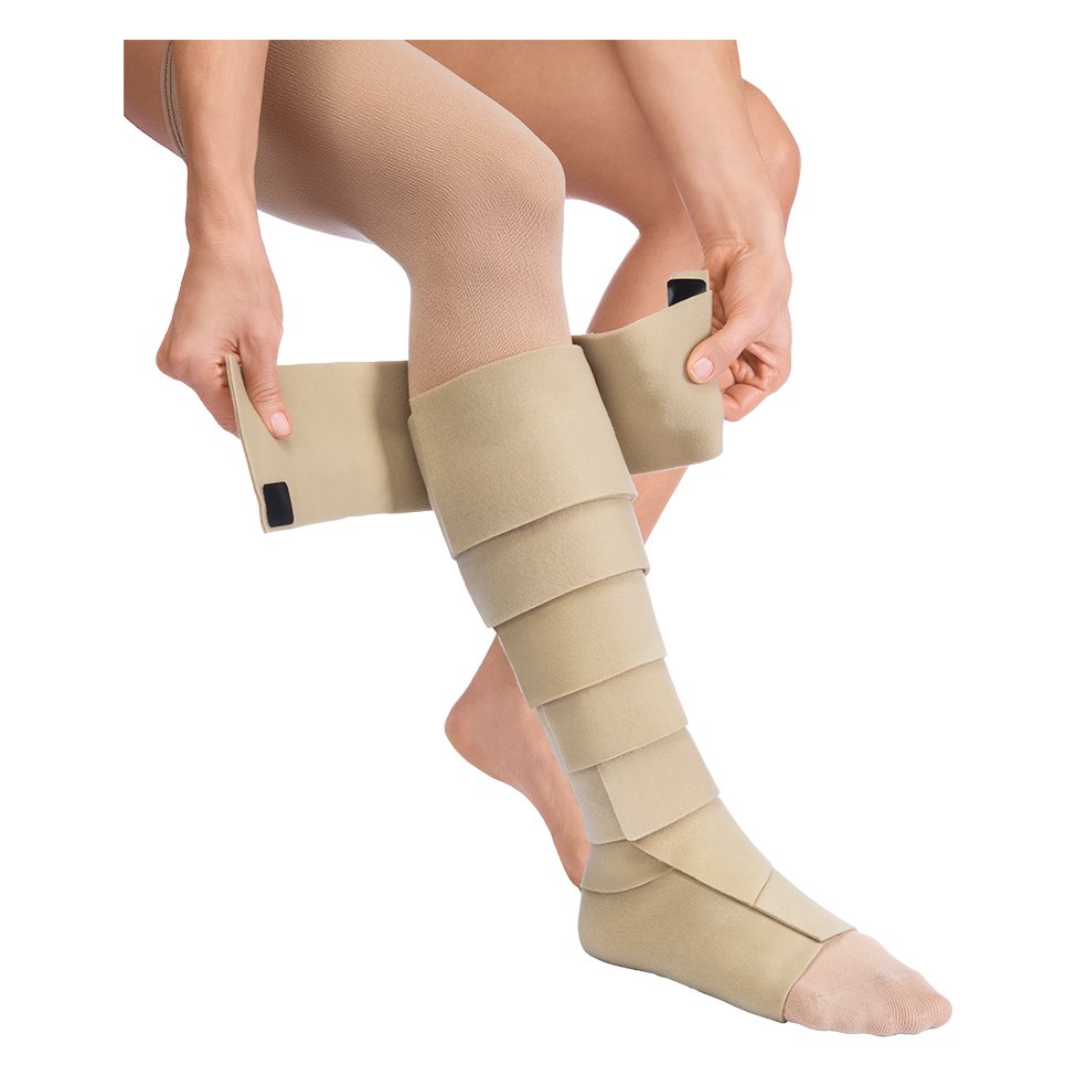 JOBST FarrowWrap Basic Legpiece being wrapped around the lower leg, showing its overlapping bands and pull tabs